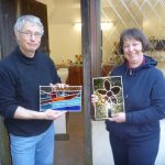 Two happy students learn to make copper foiled stained glass on a two day copper foil stained glass course in Kent