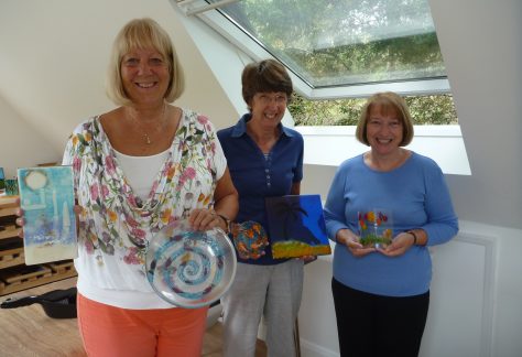 Glass fusing class proudly show off what they've made