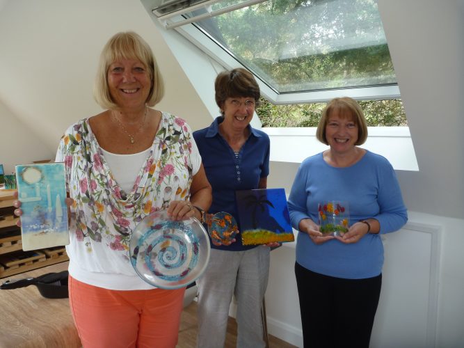 Glass fusing class proudly show off what they've made