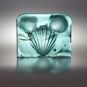 cast glass sculpture of shells, pearls and ocean waves