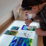 stained glass mosaic workshop - here a panel is being designed on a lightbox in our Chilham glass studio