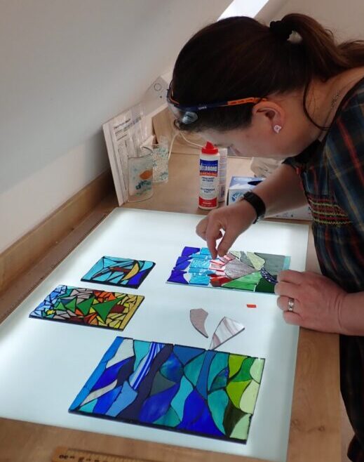 stained glass mosaic workshop - here a panel is being designed on a lightbox in our Chilham glass studio